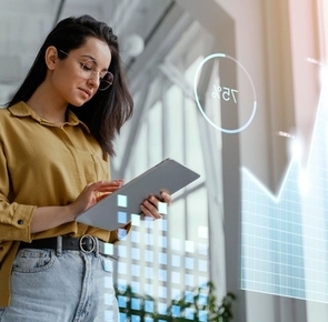 Professional analyzing digital data on a tablet, symbolizing the use of Voice AI and pattern recognition technology to enhance modern recruitment processes.